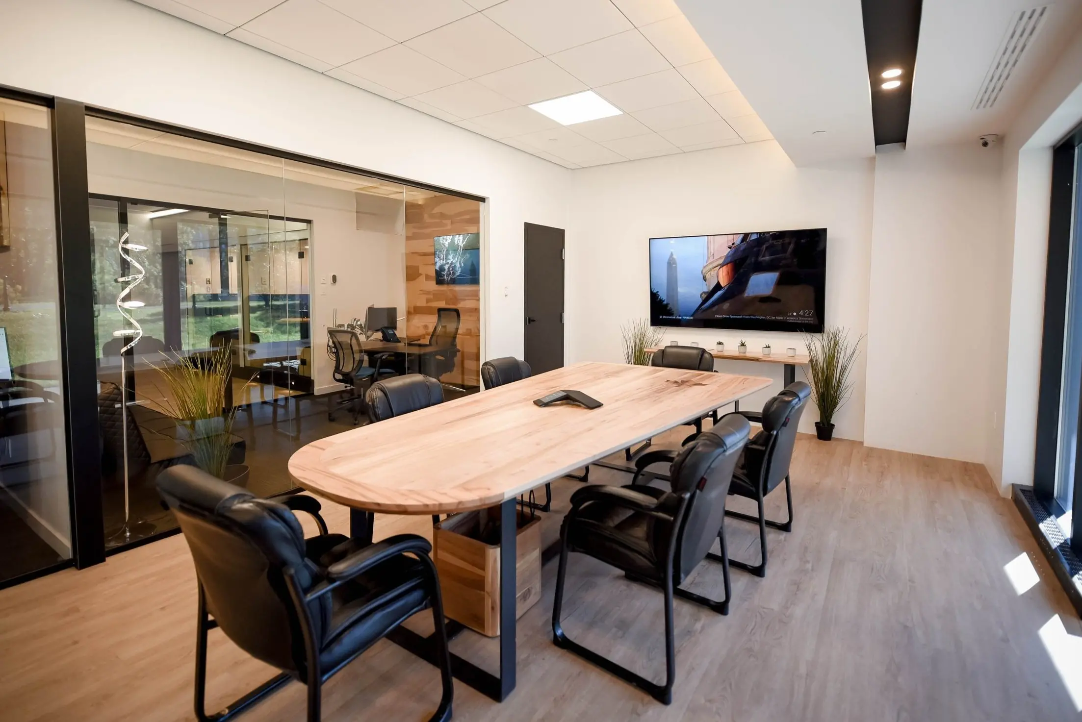 Conference room with large table, chairs, and presentation screen - free access for members